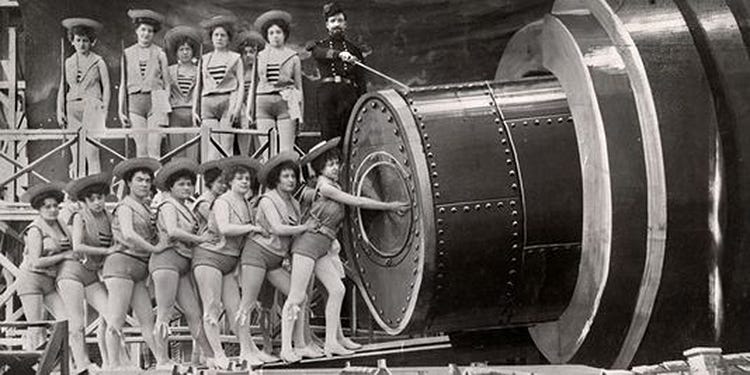 A chorus line loading a giant cannon on a painted stage set, from Le Voyage dans la Lune.